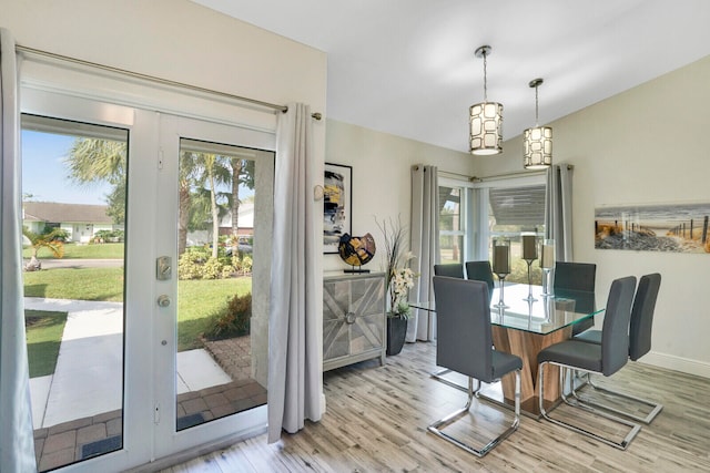 dining area with light hardwood / wood-style flooring and french doors