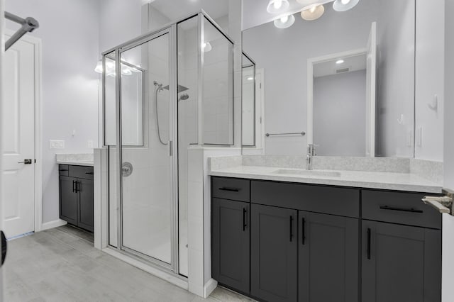 bathroom with an enclosed shower and vanity