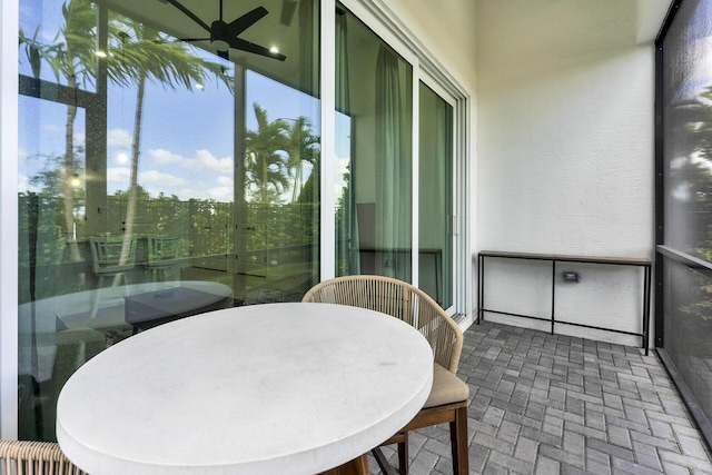 sunroom featuring ceiling fan