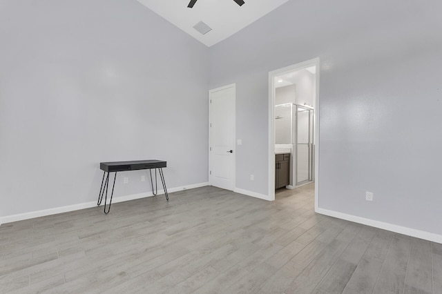 empty room featuring ceiling fan, light hardwood / wood-style flooring, and high vaulted ceiling