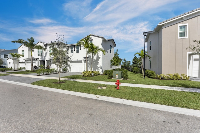 view of front of house with a garage and a front yard