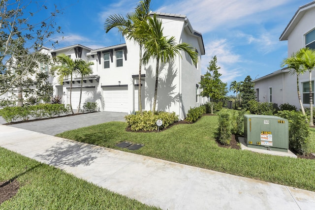 view of front facade with a front lawn and a garage