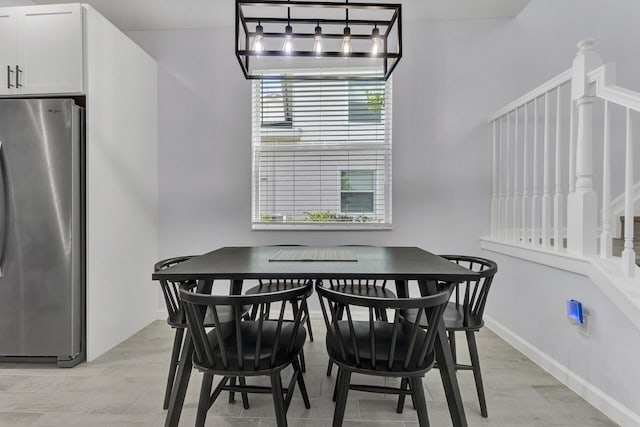 dining space with light hardwood / wood-style flooring