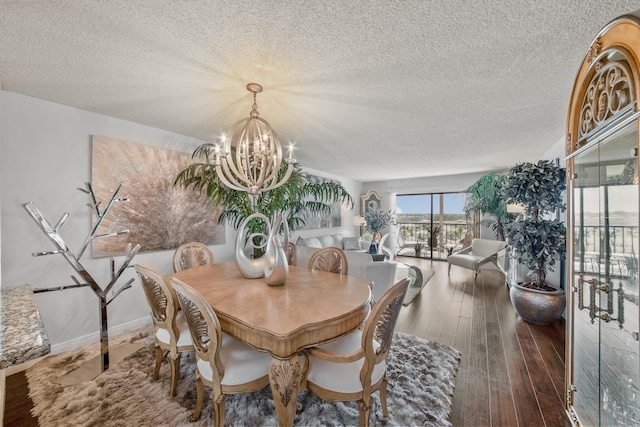 dining room featuring a notable chandelier, a textured ceiling, and dark hardwood / wood-style flooring