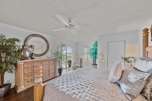 bedroom featuring a textured ceiling, dark wood-type flooring, and ceiling fan