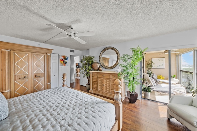 bedroom featuring a textured ceiling, access to exterior, hardwood / wood-style flooring, and ceiling fan