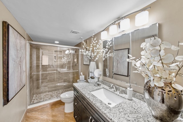 bathroom featuring vanity, tile patterned flooring, toilet, and an enclosed shower