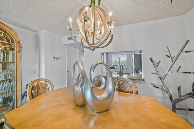 dining room featuring a textured ceiling and a chandelier