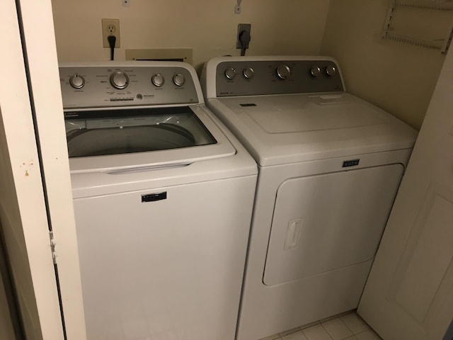 washroom featuring light tile patterned flooring and washer and dryer