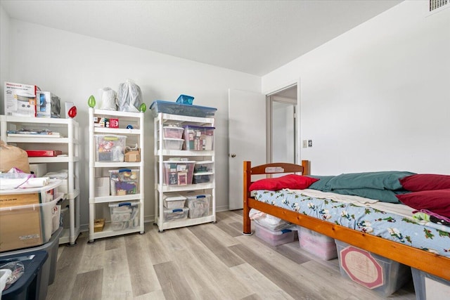 bedroom with light hardwood / wood-style flooring