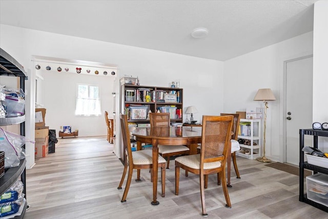 dining space with light hardwood / wood-style flooring