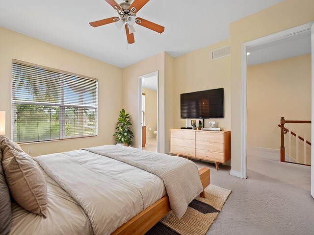 carpeted bedroom featuring connected bathroom and ceiling fan