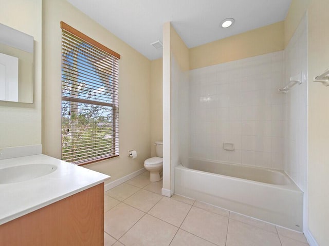 full bathroom with vanity, toilet, tile patterned flooring, and tiled shower / bath