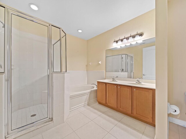 bathroom featuring vanity, tile patterned floors, and separate shower and tub