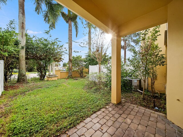 view of yard featuring central air condition unit and a patio area