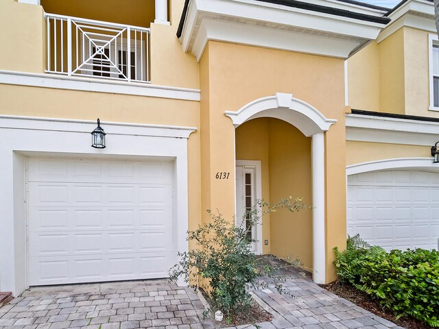 doorway to property with a garage