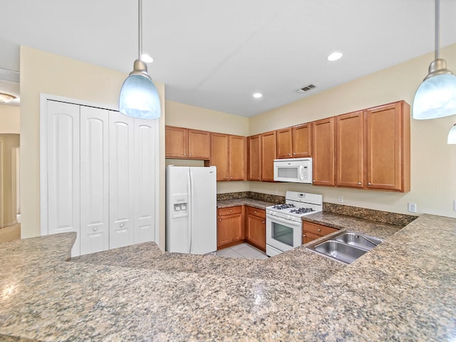 kitchen with sink, decorative light fixtures, and white appliances