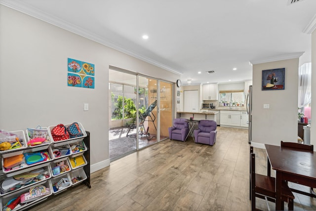 interior space featuring light hardwood / wood-style flooring and crown molding