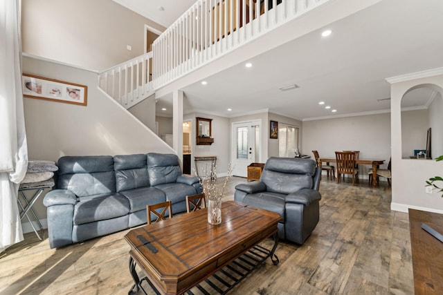 living room featuring wood-type flooring and ornamental molding