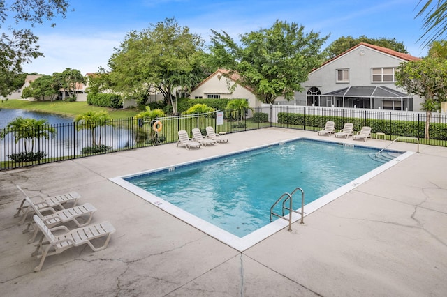 view of swimming pool with a patio and a water view