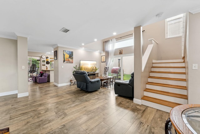 living room featuring light hardwood / wood-style flooring and ornamental molding