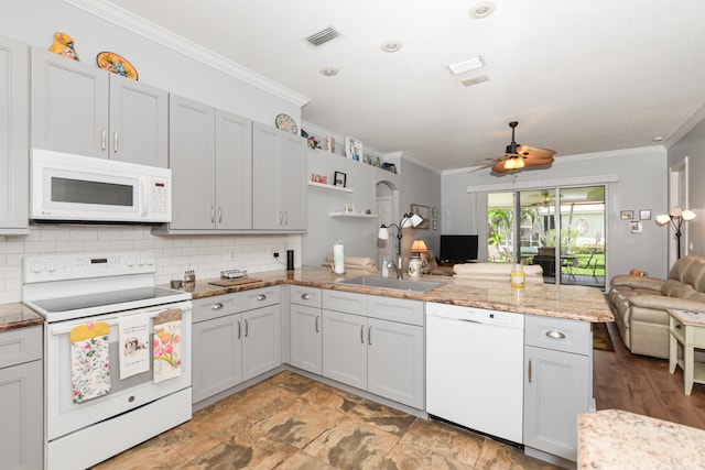 kitchen featuring ornamental molding, white appliances, sink, kitchen peninsula, and ceiling fan