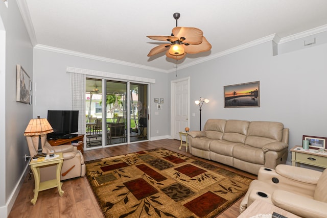 living room featuring ceiling fan, wood-type flooring, and crown molding