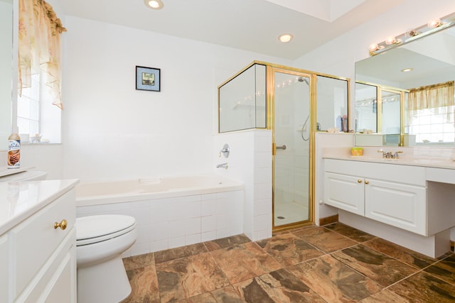 full bathroom featuring toilet, vanity, and separate shower and tub