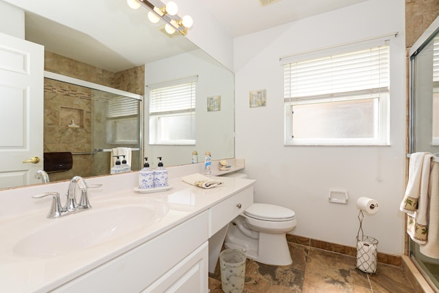 bathroom with vanity, toilet, and a shower with shower door