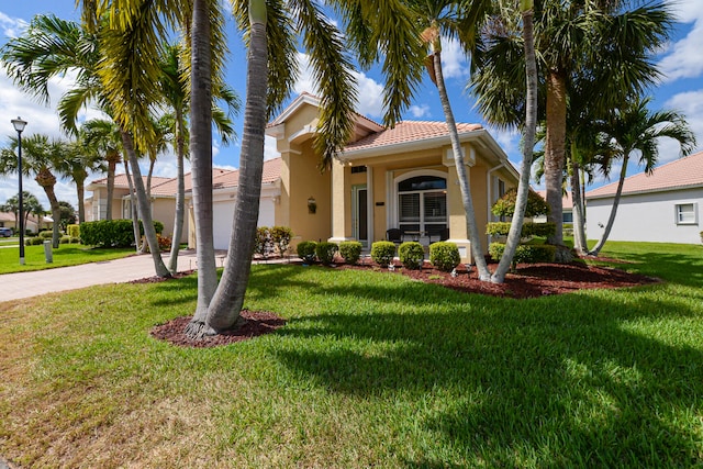 mediterranean / spanish house with a front lawn