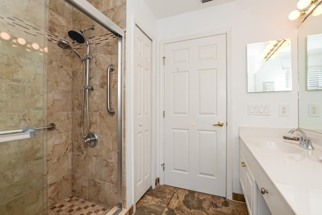 bathroom with walk in shower and vanity