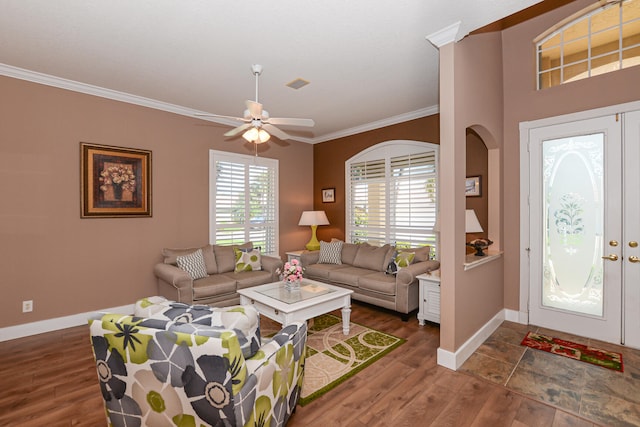 living room with a wealth of natural light, dark hardwood / wood-style floors, and crown molding