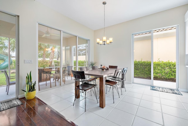 tiled dining area with a chandelier