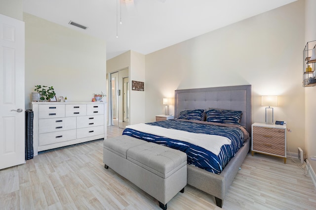 bedroom featuring light hardwood / wood-style flooring, a closet, and ceiling fan