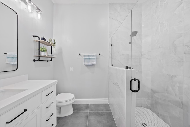 bathroom with a shower with door, vanity, toilet, and tile patterned flooring