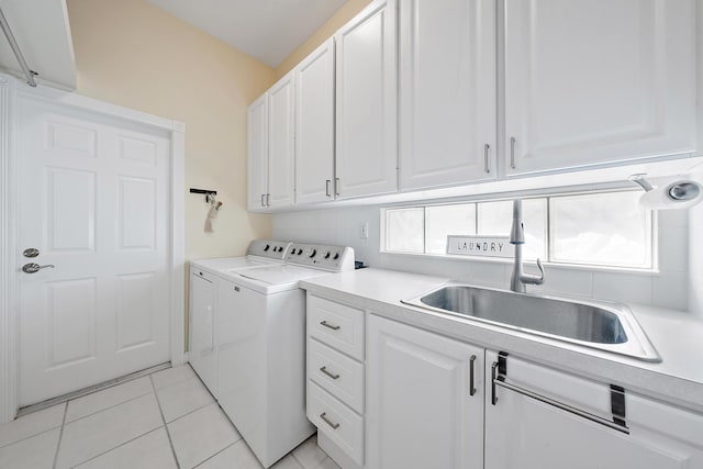 laundry room with sink, a healthy amount of sunlight, cabinets, and separate washer and dryer