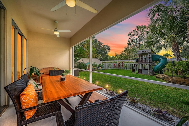 sunroom featuring ceiling fan