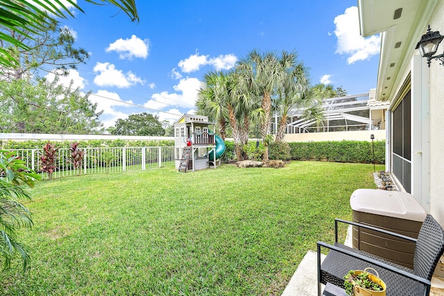 view of yard featuring a lanai and a playground