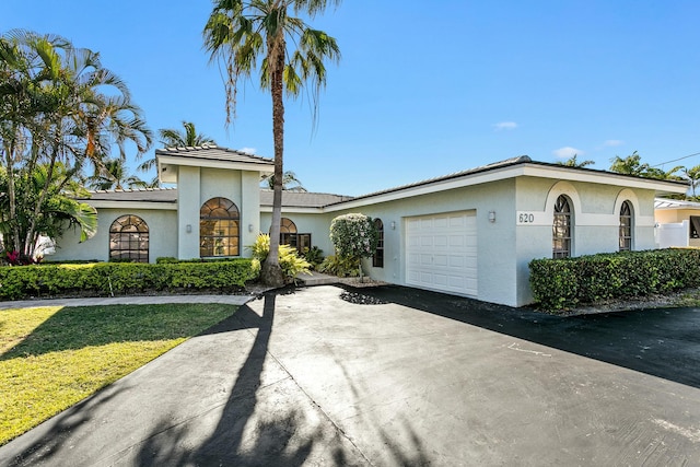 view of front of property with a front yard and a garage