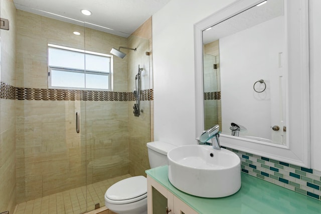 bathroom with vanity, toilet, and a shower with shower door