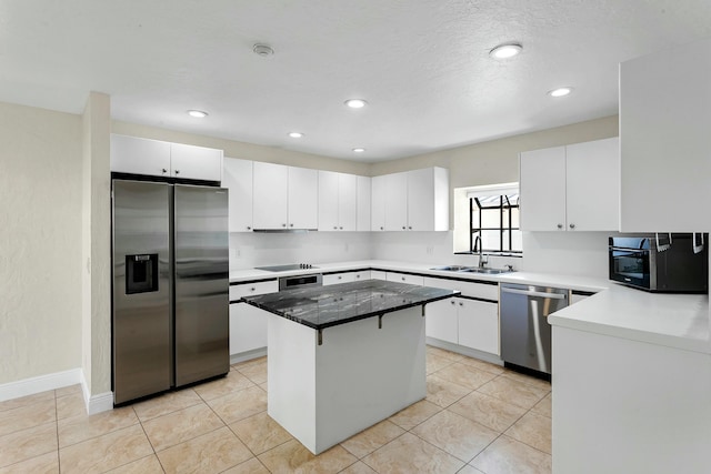 kitchen with a center island, sink, light tile patterned flooring, white cabinetry, and stainless steel appliances