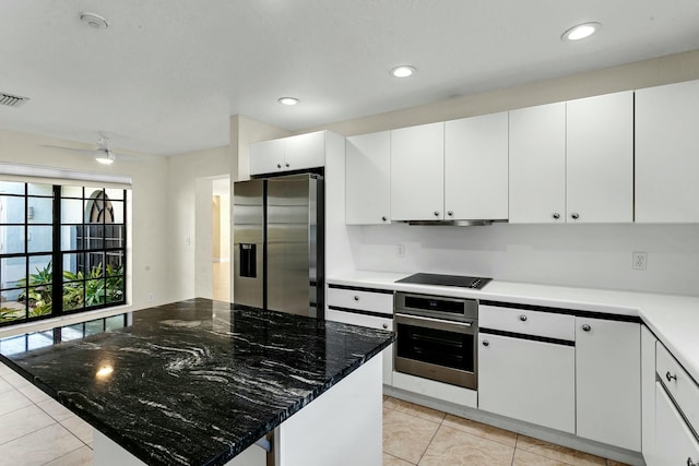 kitchen with a center island, white cabinets, ceiling fan, appliances with stainless steel finishes, and light tile patterned flooring