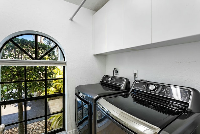 laundry area featuring cabinets and washing machine and clothes dryer