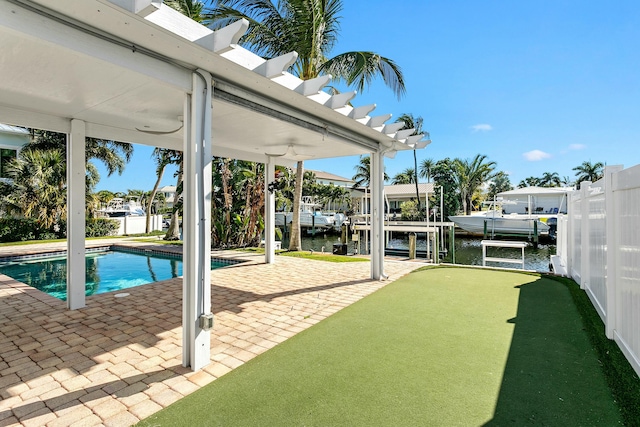 view of swimming pool featuring a water view, a patio, and a boat dock