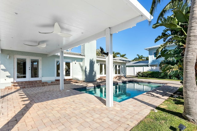 view of pool featuring ceiling fan, a patio area, and french doors