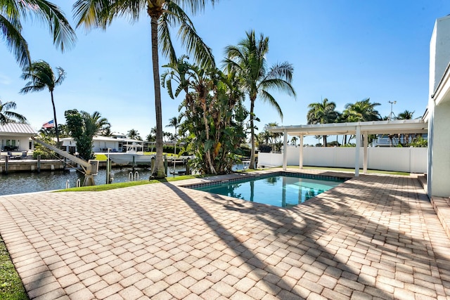 view of pool featuring a boat dock, a patio area, and a water view