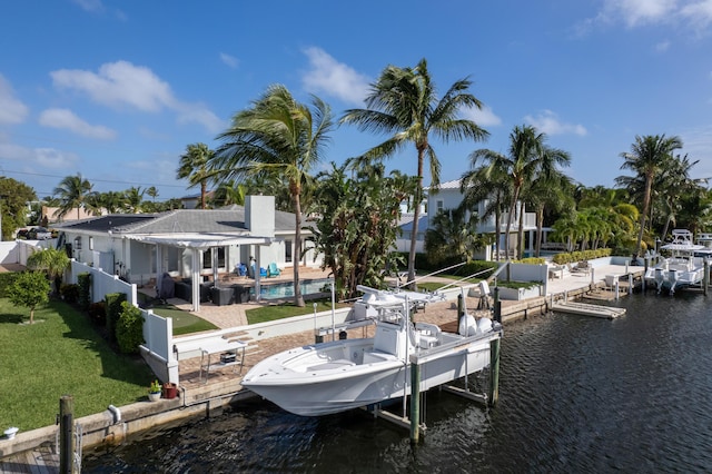 dock area with a water view, a yard, and a patio