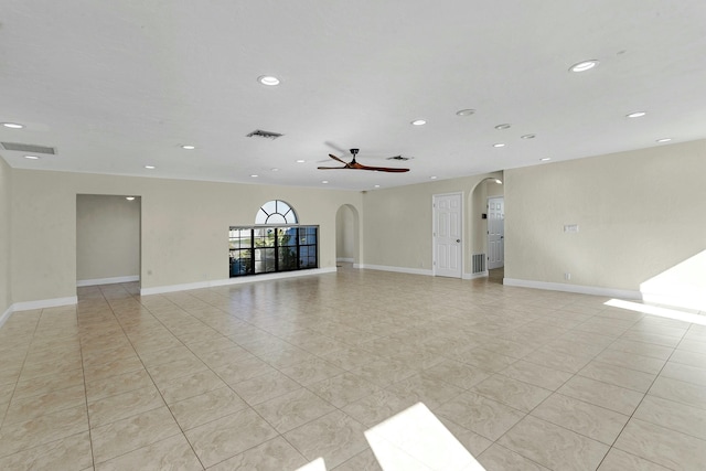 tiled spare room featuring ceiling fan