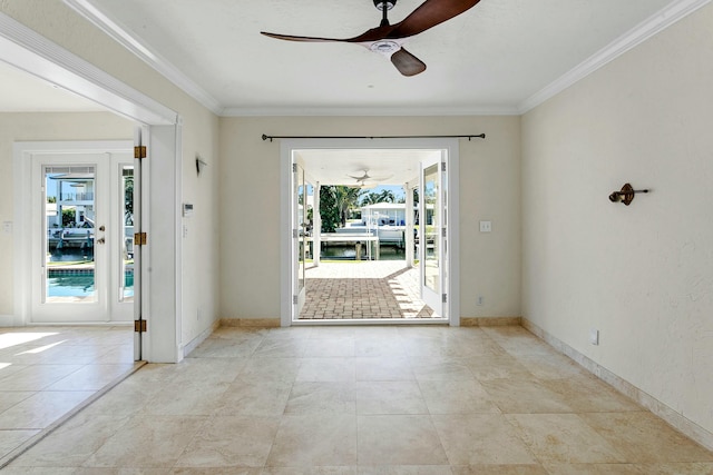 entryway with crown molding, ceiling fan, and a healthy amount of sunlight