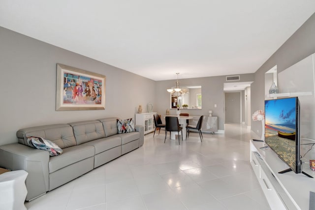 tiled living room with a chandelier